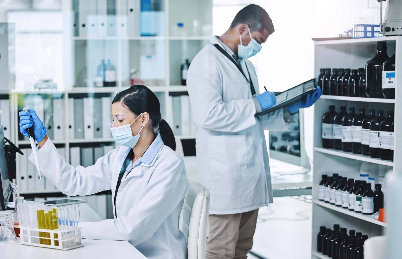 Heroes in labcoats. Shot of two young researchers working in a laboratory