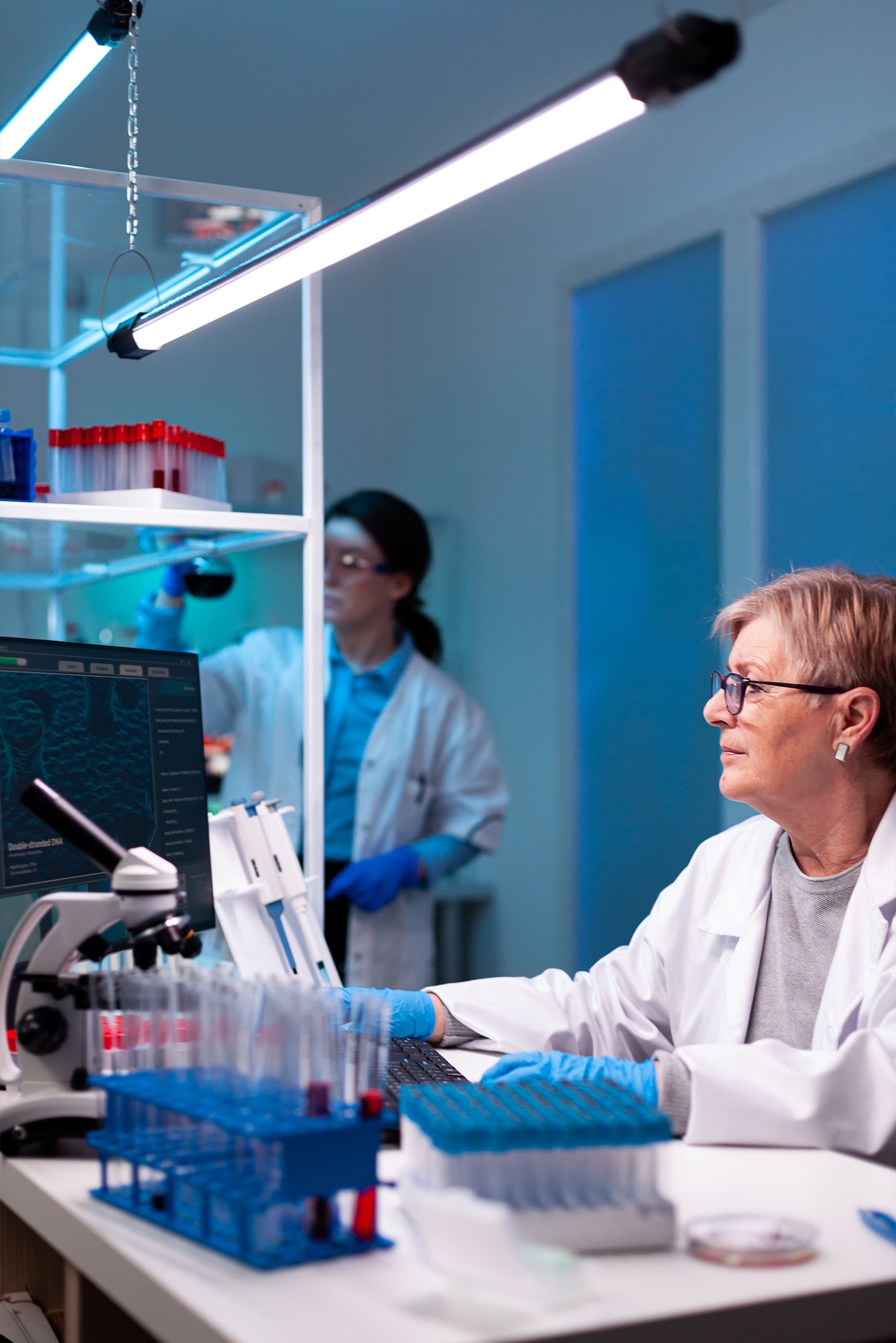 Senior-doctor-in-white-coat-working-on-computer-2023-01-04-19-19-37-utc